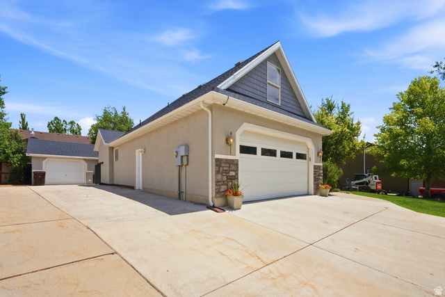 5196 Rodeo Circle Oakley, UT 84055 - Photo 8 of 57 Two-car garage with stone accents and an additional detached garage structure