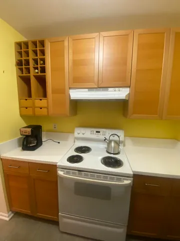a kitchen with a stove and a cabinet