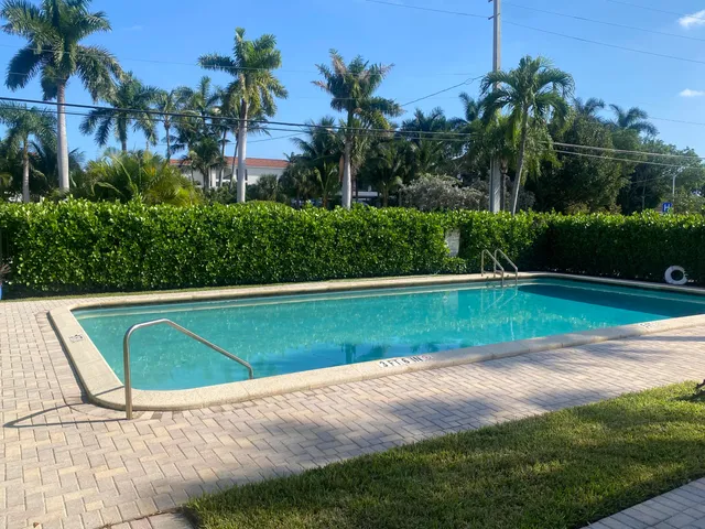 a view of yard with swimming pool and green space