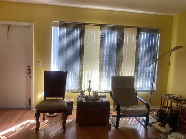 a view of a workspace with furniture and a window