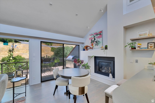 510 Spring Creek Road Providence, UT 84332 - Photo 12 of 97 Vaulted ceiling interior featuring a built-in fireplace with a black surround and an exterior sliding glass door leading to a deck