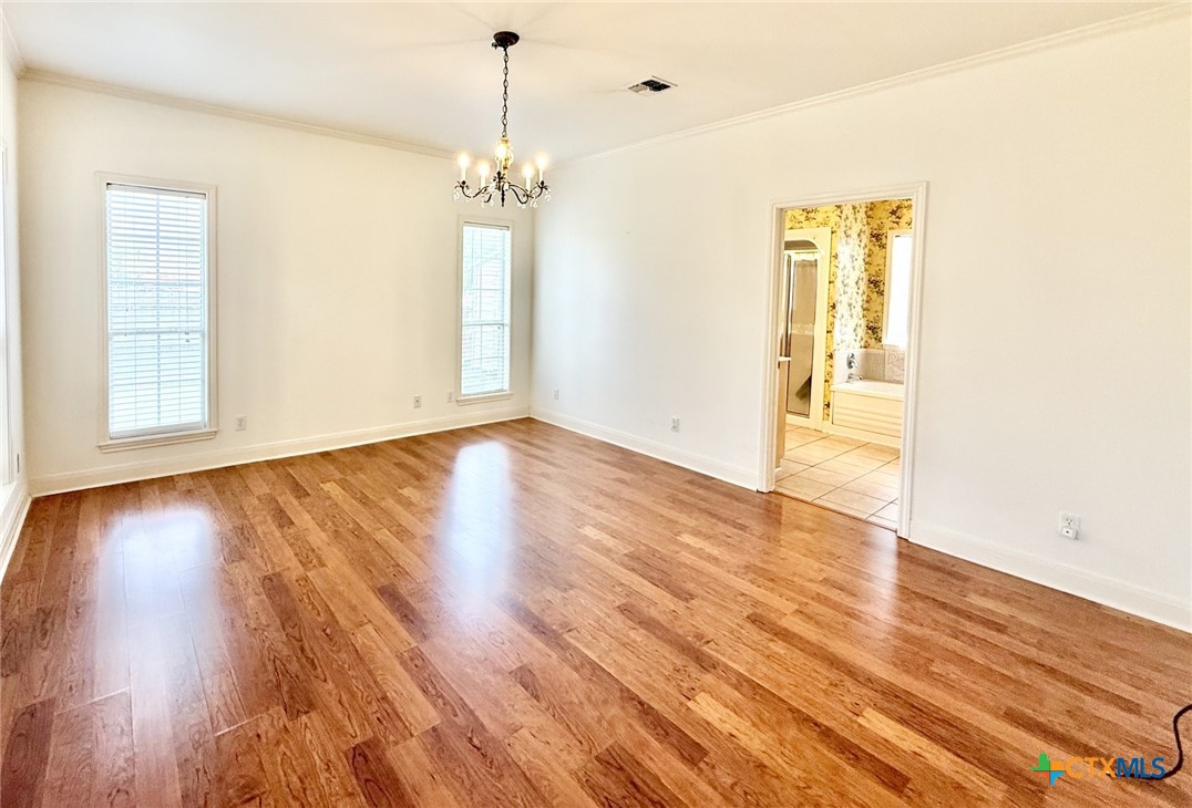 415 South Trinity Street Edna, TX 77957 - Photo 22 of 46 a view of empty room with wooden floor and fan