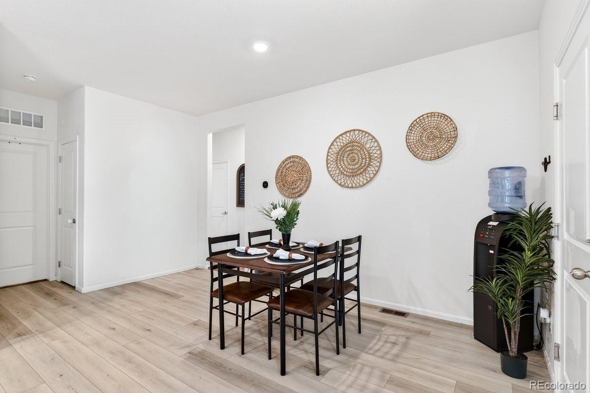 7227 Vermillion Street Frederick, CO 80530 - Photo 14 of 28 a view of a dining area with furniture and wooden floor