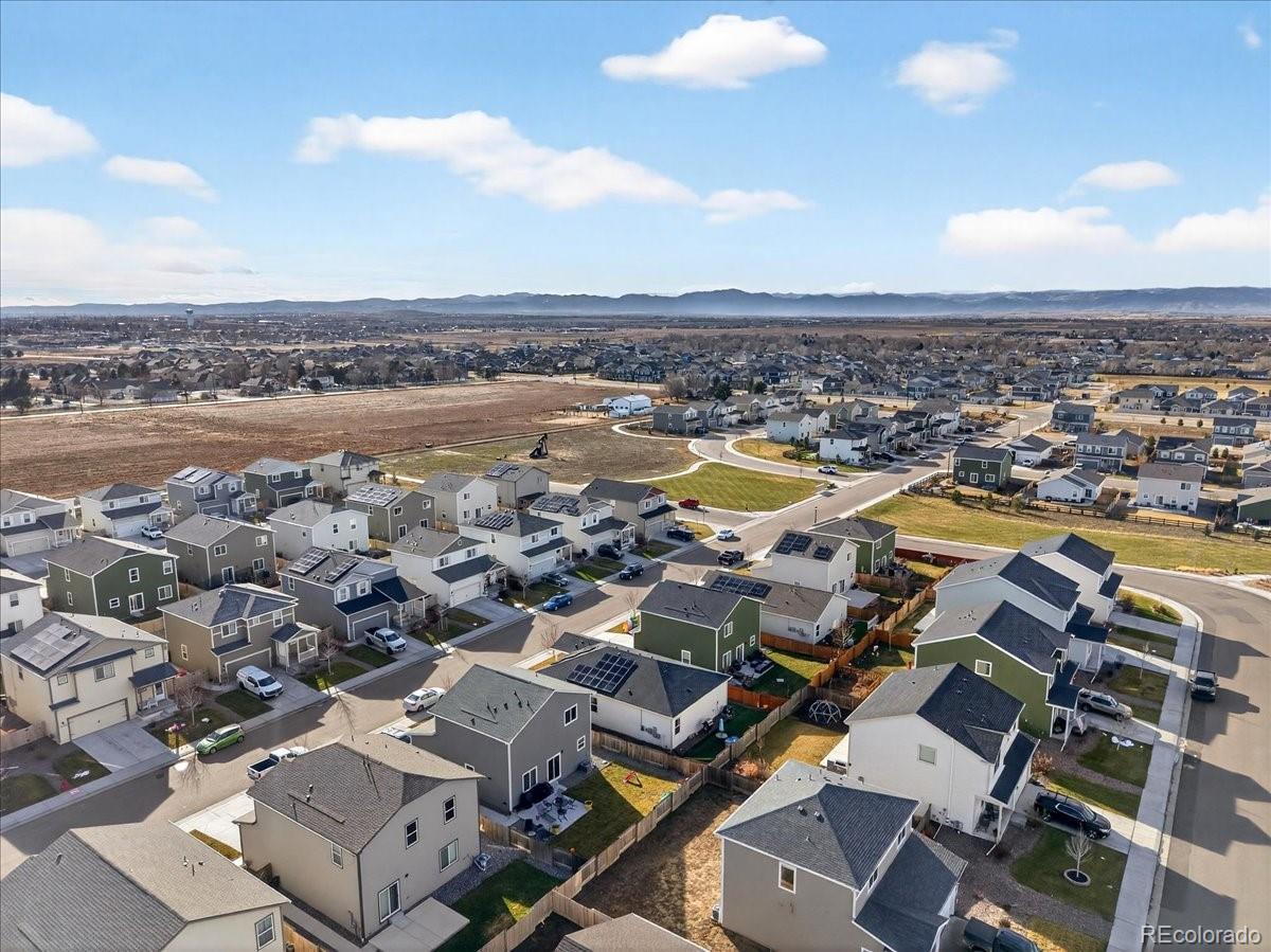 7227 Vermillion Street Frederick, CO 80530 - Photo 27 of 28 an aerial view of a city with lots of residential buildings and ocean view in back