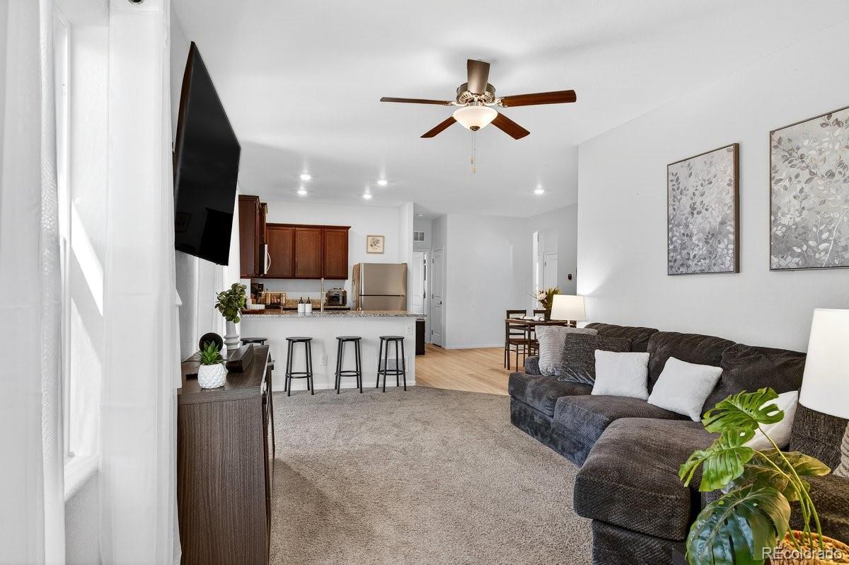 7227 Vermillion Street Frederick, CO 80530 - Photo 5 of 28 a living room with furniture and a flat screen tv