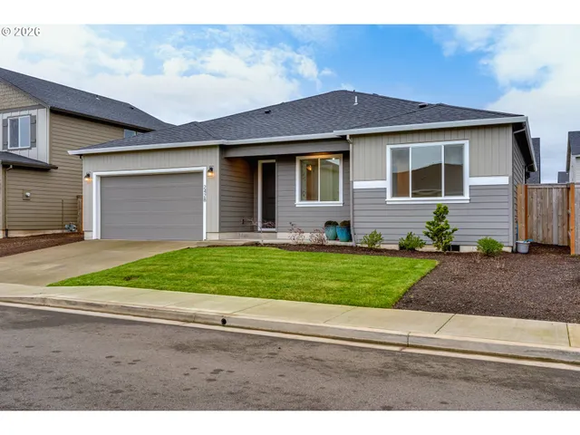 a front view of a house with a garden and plants