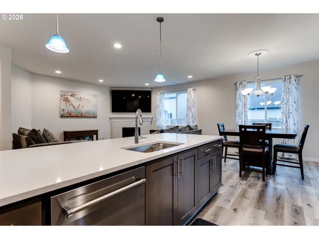 a kitchen with a sink a counter space appliances and cabinets