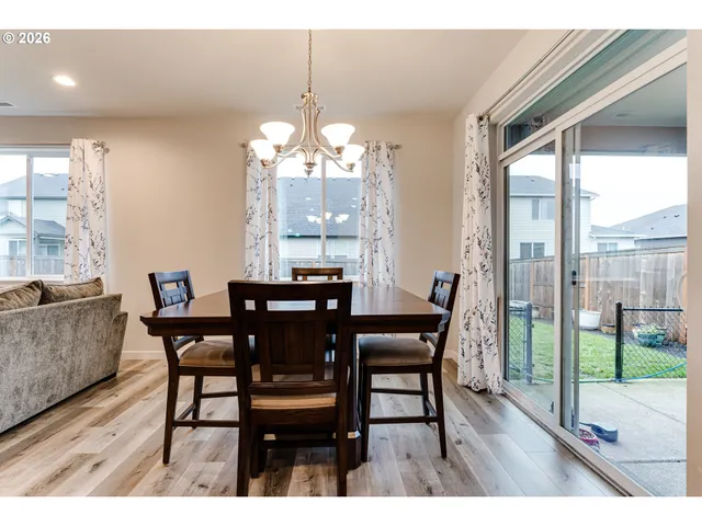 a view of a dining room with furniture wooden floor and chandelier