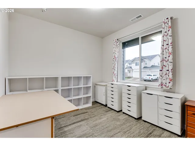 a kitchen with white cabinets and wooden floor