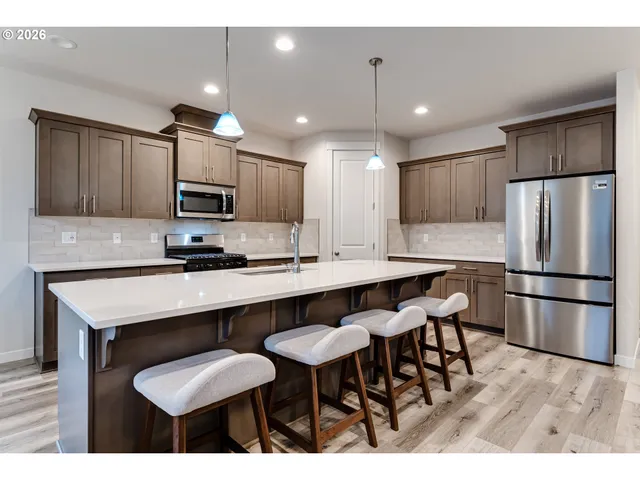 a kitchen with kitchen island appliances and wooden cabinets