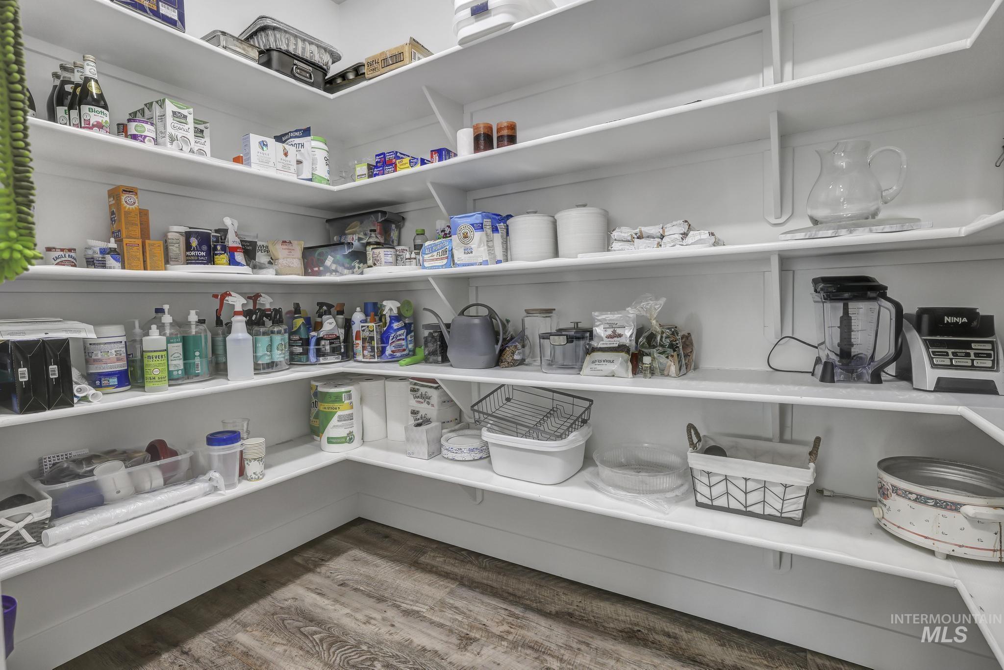 1937 Tamarack Loop Twin Falls, ID 83301 - Photo 19 of 50 Corner pantry featuring extensive white shelving, wood-finish flooring, and recessed lighting