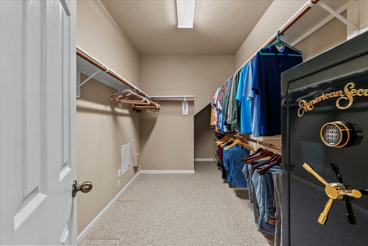 3902 Basil Court Pearland, TX 77584 - Photo 22 of 50 Experience the luxury of a spacious walk-in closet with generous hanging space, shelving, plush carpeting, and a built-in safe for secure storage.