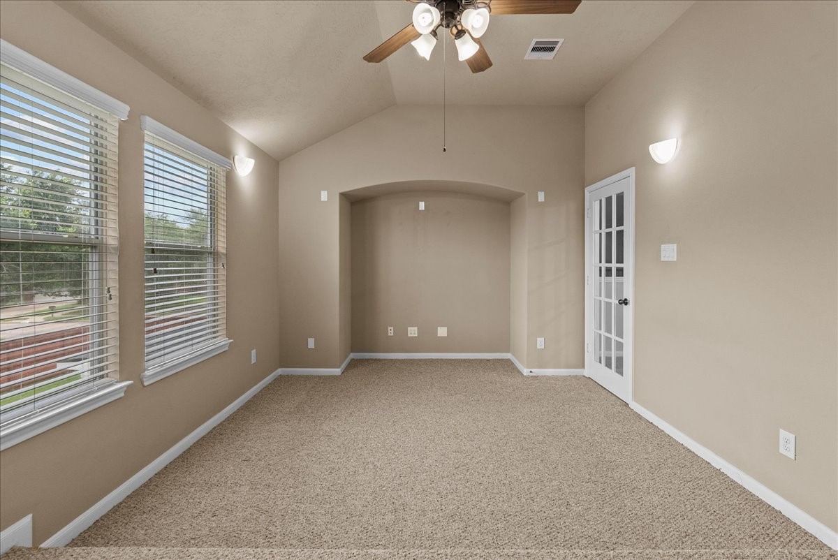 3902 Basil Court Pearland, TX 77584 - Photo 26 of 50 The Media Room features neutral walls and carpet, a ceiling fan with lights, and ample natural light from two large windows. It includes%2