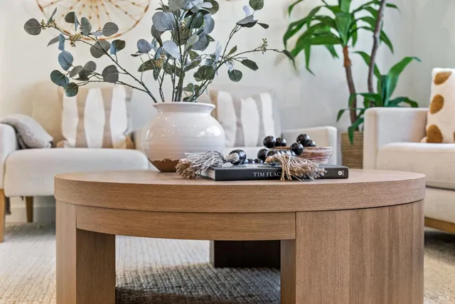 a sitting area with window and furniture