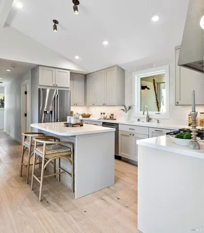 a bathroom with a granite countertop sink mirror vanity bathtub and a toilet