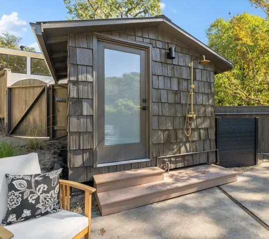 a view of a house with backyard and sitting area