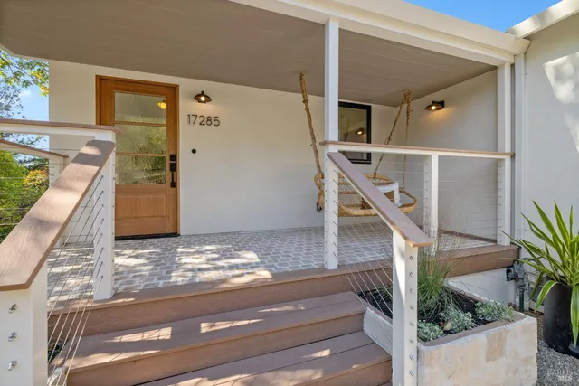 a backyard of a house with table and chairs