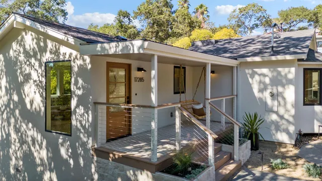a living room with furniture and a mirror