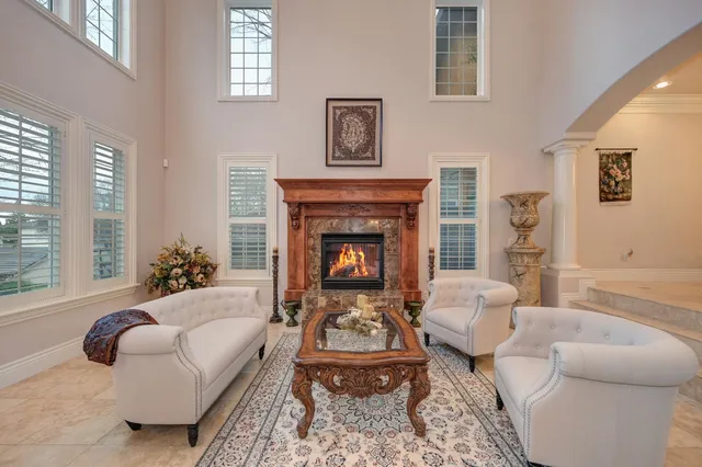a living room with furniture a fireplace and a flat screen tv