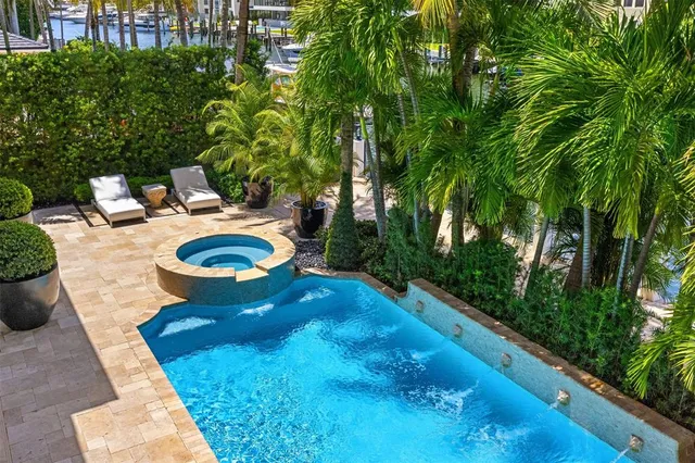 a front view of a house with large windows and a potted plant