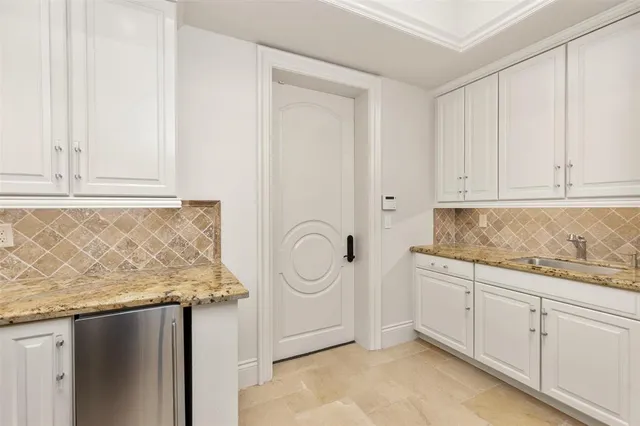a view of a dining room with furniture and a bathroom