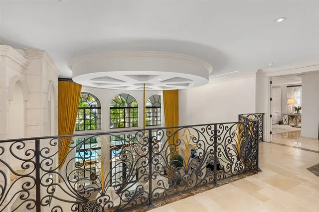 a spacious bedroom with a large bed and a chandelier