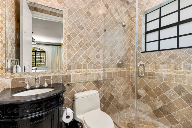 a bedroom with a large bed and a chandelier