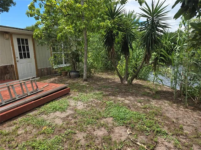 a view of a backyard with chairs