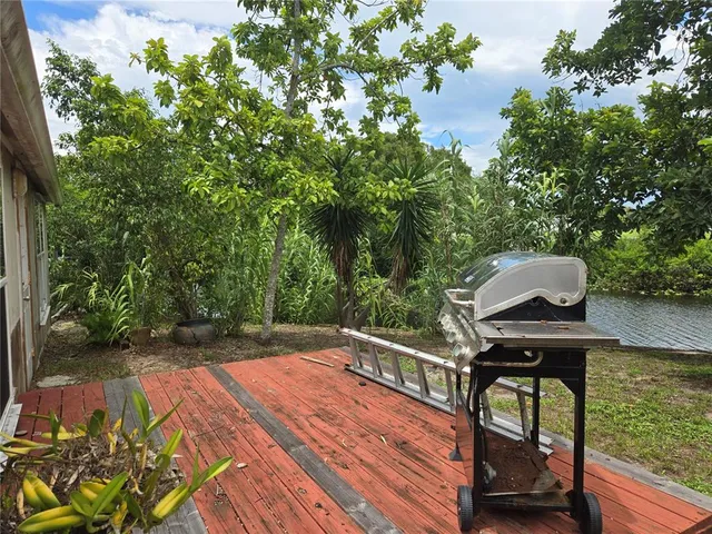 a view of backyard with deck and outdoor seating