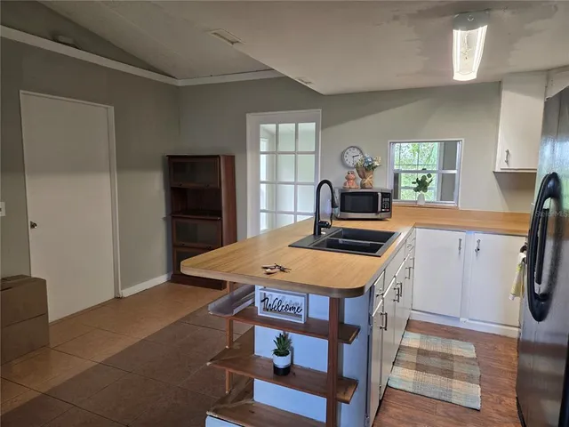 a kitchen with a stove a refrigerator and a dining table