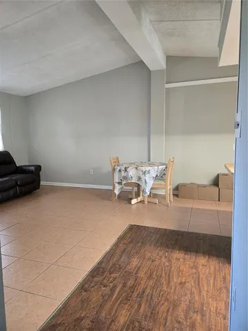 an empty room with a window and a ceiling fan