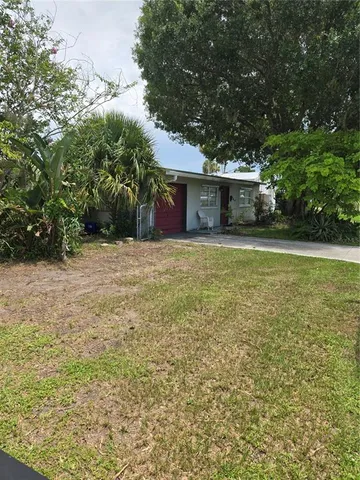 a front view of a house with a yard and a garage