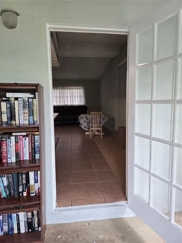 a living room with furniture and a gym machine