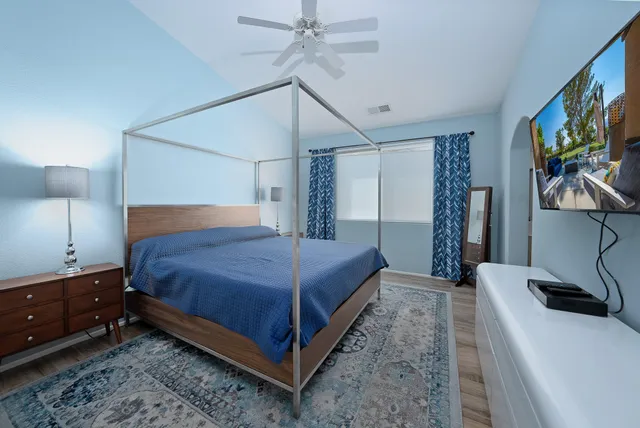 a bedroom with a bed and a flat screen tv