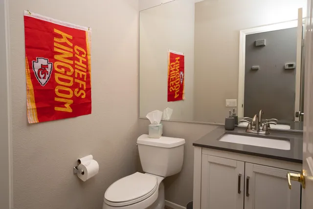 a bathroom with a toilet sink and mirror