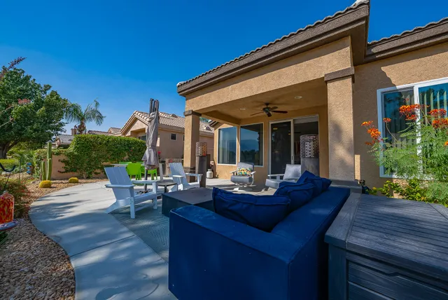 a view of a house with backyard porch and sitting area