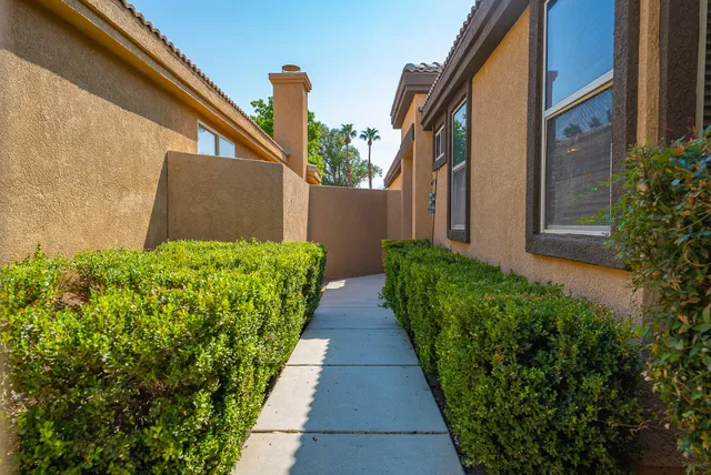 a view of a pathway both side of house
