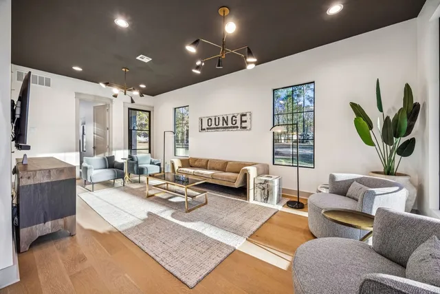 a living room with furniture rug and a table