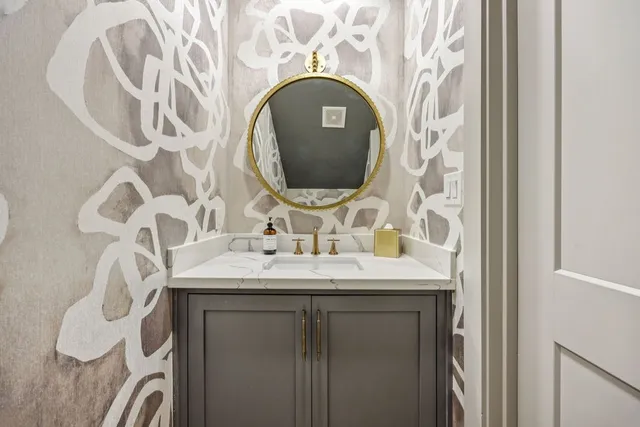 a bathroom with a sink and mirror
