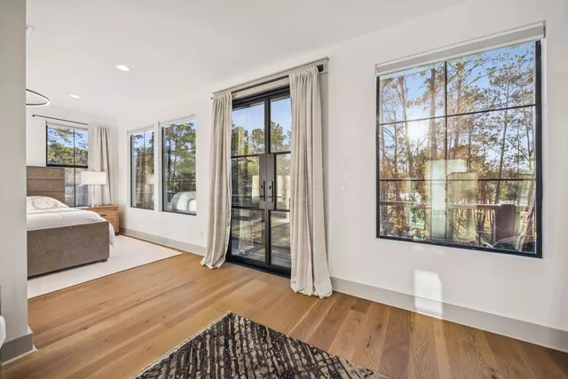 a spacious bedroom with a bed and a large window