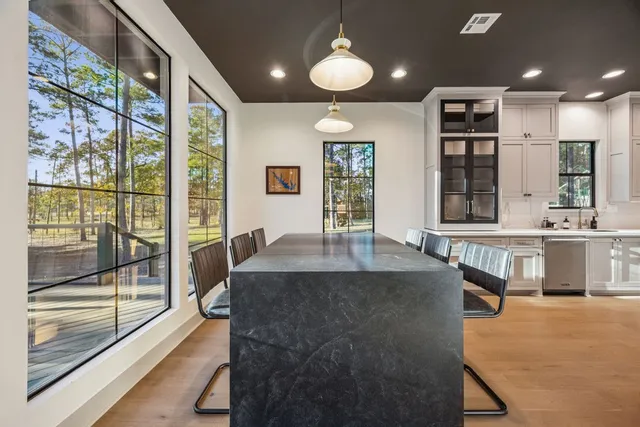 a large kitchen with granite countertop a large window and a counter space
