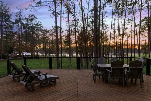 a view of a dinning table and chairs on the deck
