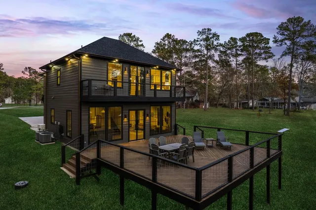 a backyard of a house with table and chairs