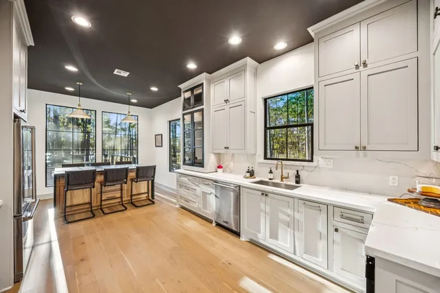 a large kitchen with kitchen island a large window