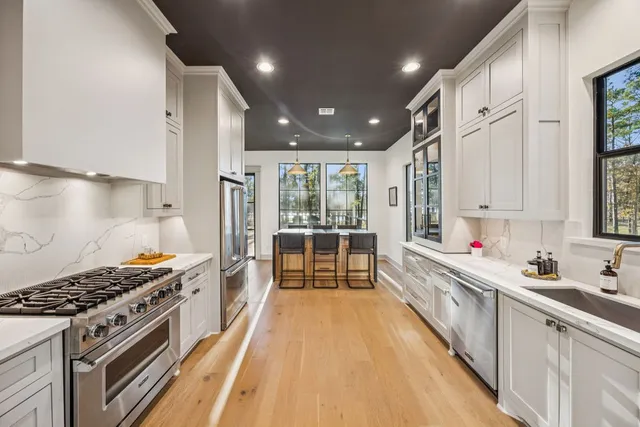 a kitchen with stainless steel appliances a stove a sink and a refrigerator