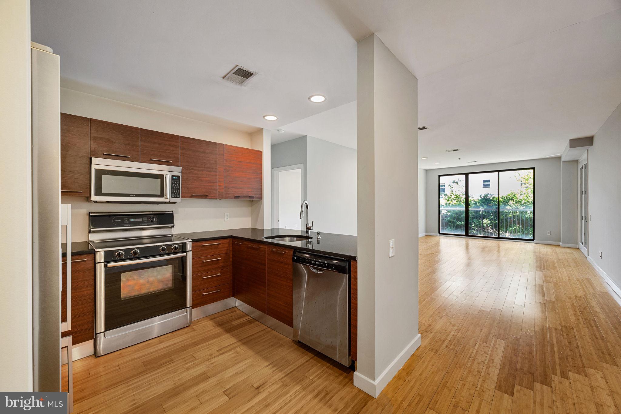 934 North 3rd Street, Unit 205 Philadelphia, PA 19123 - Photo 1 of 39 a kitchen with stainless steel appliances granite countertop a stove top oven and sink
