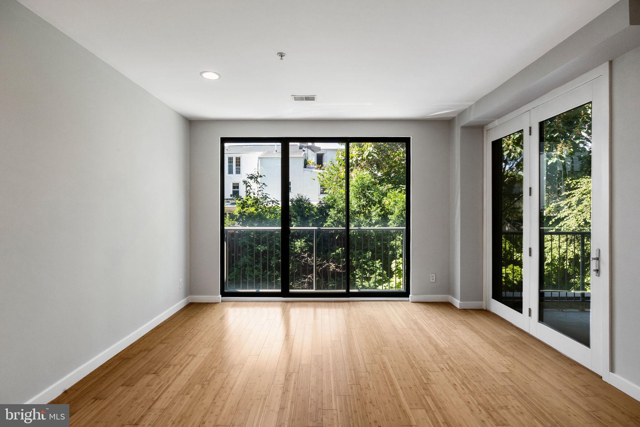 934 North 3rd Street, Unit 205 Philadelphia, PA 19123 - Photo 11 of 39 a view of an empty room with wooden floor and a window