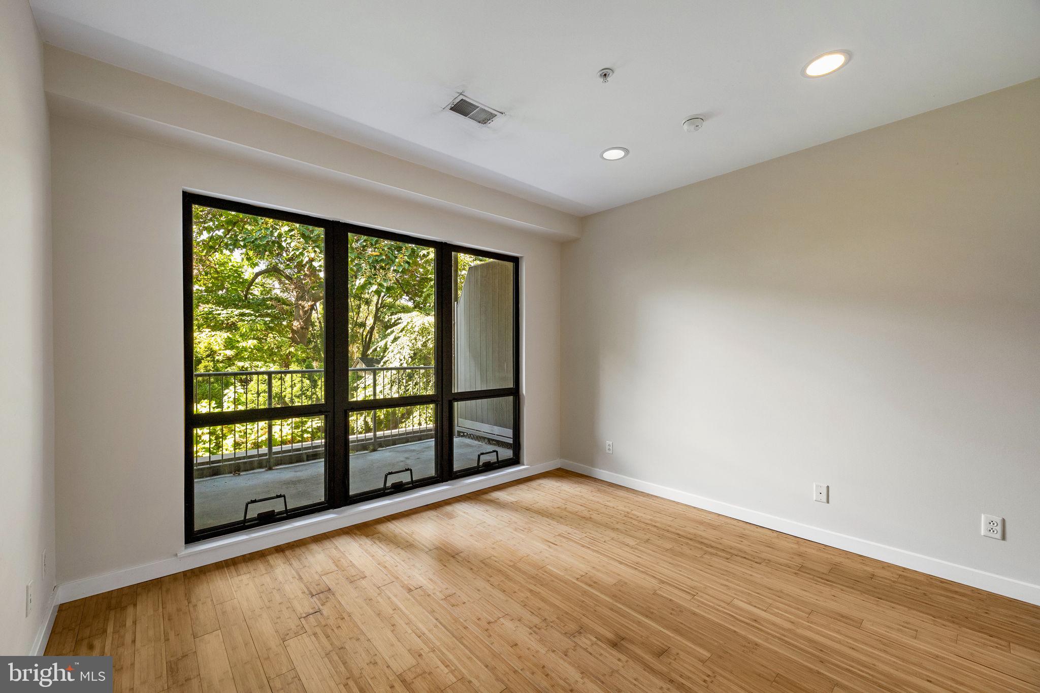 934 North 3rd Street, Unit 205 Philadelphia, PA 19123 - Photo 18 of 39 an empty room with wooden floor and windows