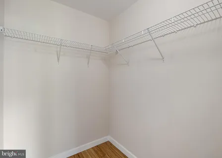 a bathroom with a granite countertop toilet a sink and a mirror