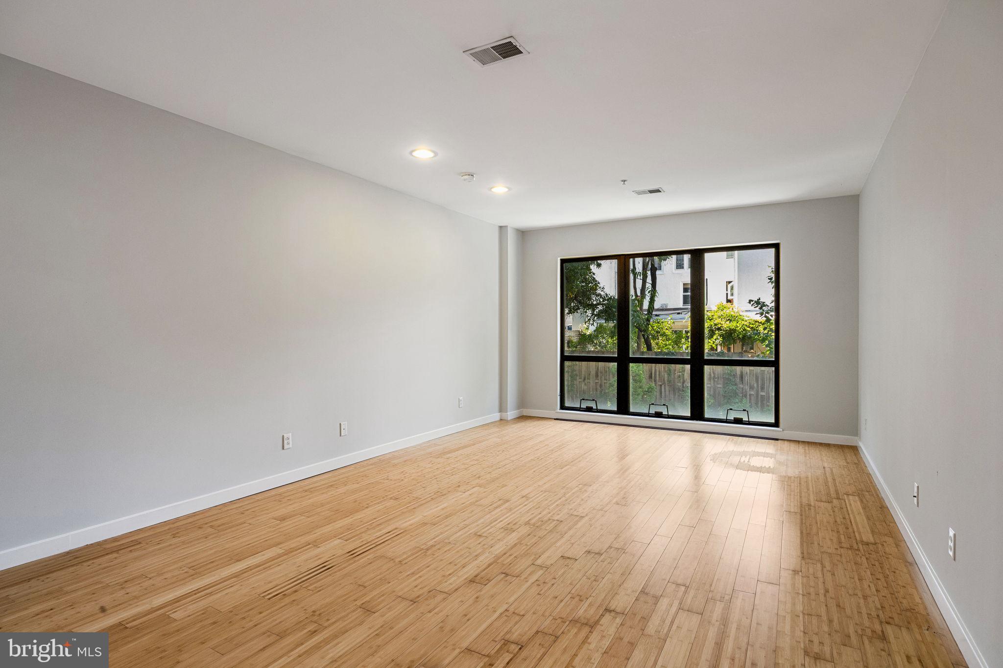 934 North 3rd Street, Unit 205 Philadelphia, PA 19123 - Photo 22 of 39 a view of an empty room with wooden floor and a window